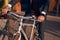 Crop entrepreneur riding bike on street