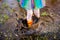 Crop girl splashing puddle in sunlight