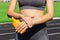 Crop image of a woman protecting her hands and arms with sunblock before training at the stadium on a sunny day. Skincare concept