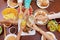 Crop people clinking with glasses above festive table