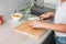 Crop photo of slim girl young woman cuts lemon in kitchen