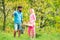 Crop planting at fields. Farmars couple enjoy spring nature and take care about her plants. Portrait of a young happy