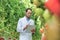 Crop scientist writing report on clipboard in greenhouse