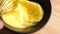 Crop shot of preparing homemade omelette mixing with whisk eggs in slow motion