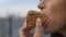 Crop shot of woman eating hot dog