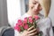 Crop smiling woman holding roses