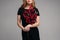 Crop Smiling young girl in black dress keeping branch in hand