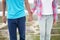 Crop of teenage girl and boy holding hands