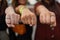 Crop of three girls showing her stylish manicure, holding their fingers on black leather handbag. Different design of