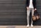 Crop trendy man leaning on wall on street