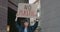 Crop view of girl with no plastic carton placard standing at city street and shouting. Woman supporting ecology strike