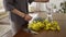 Crop view of woman arranging yellow blossom gorse