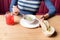 Crop of woman holding spoon and white bowl of mushroom cream soup. Woman eating first dish on dinner, french onion cheesy soup.