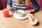 Crop of woman holding spoon and white bowl of mushroom cream soup. Woman eating first dish on dinner, french onion cheesy soup.