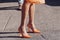 Crop woman in orange shoes