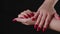 Crop woman with red nail polish. High angle of crop faceless female showing hands with red manicure against black