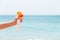 Croped image of woman`s hand holding sunblock spray at the beach