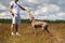 Croped Man giving water to dog while walking