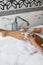 Cropped african woman shaving legs in bathroom. black female using razor to remove hair, close-up photo