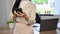 Cropped, Asian businesswoman standing in her office, using smartphone