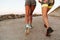 Cropped back view image of two fitness women running outdoors