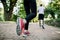 Cropped back view of unrecognizable multiethnic athletic couple running and warming up in sunny summer park. Focus on