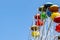 Cropped big Ferris Wheel in entertainment park with a blue sky behind with copy space