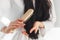 Cropped brunette woman in bathrobe brushing hair close-up view