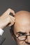 Cropped Businessman In Glasses Scratching Bald Head