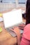 Cropped businesswoman working on laptop in office