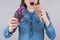 Cropped close up photo of happy delightful positive crazy food eater teenager holding ice cream in hands trying to eat both