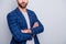 Cropped close up photo of masculine virile man with arms crossed in checkered blazer isolated grey color background