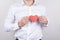 Cropped close-up photo portrait of cheerful handsome dream dreamy nice lovely cute tender glad positive smiling guy holding heart