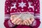 Cropped close up photo portrait of hands holding tangled christmas white lights wearing maroon sweater with dears isolated on