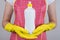 Cropped close up photo of satisfied wife using holding in hands bottle of liquid soap for cleaning kitcheware dishware isolated