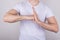 Cropped close up photo of serious confident guy giving punch to the palm showing his determination isolated over gray color