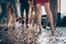 Cropped close-up photo of slim legs girls guys meeting rejoicing dance floor x-mas party glitter flying wear luxury