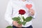 Cropped close up portrait photo of handsome charming sincere gentleman holding bright big large flower with tender gentle