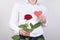 Cropped close up portrait photo of handsome charming sincere gentleman holding bright big large flower with tender gentle