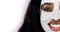 Cropped close up portrait of pretty smiling African girl with antiaging lifting mask applied on her face, isolated on