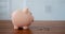 Cropped close-up shot of piggy bank concept to collect money. A woman\'s hand loads money replenishing a piggy bank