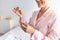 Cropped close up of woman holding bottle of serum