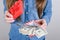 Cropped closeup photo of fortunate lucky astonished amazed cool day lady finding stack pile of money in small box with ribbon bow