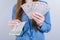 Cropped closeup photo of rich wealthy lady businesswoman holding pile stack of money in hands  grey background