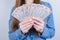 Cropped closeup photo of ukraine money holding in hands beautiful lady  grey background