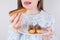 Cropped closeup photo of woman want to eat delicious eclair isolated grey background