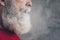 Cropped closeup profile photo of aged guy with perfect groomed long beard after salon procedure wear red knitted