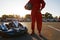 Cropped closeup shot of go-kart driver holding helmet in hands