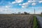 Cropped corn fields and a road towards farms at the Flemish countryside around Ternat, Belgium