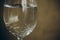 Cropped glass of white wine on a rustic wooden brown background. rest, holiday, party. alcoholic drink closeup. copy space